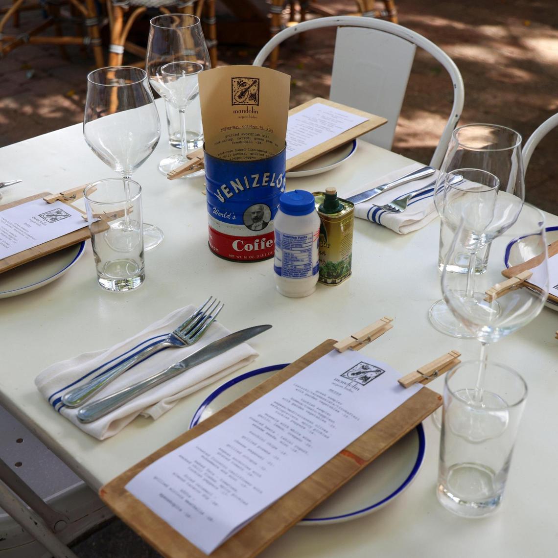 The table setting takes on a Mediterranean flavor reminiscent of Aegean outdoor cafes at Mandolin, where the daily specials are presented in a coffee can.