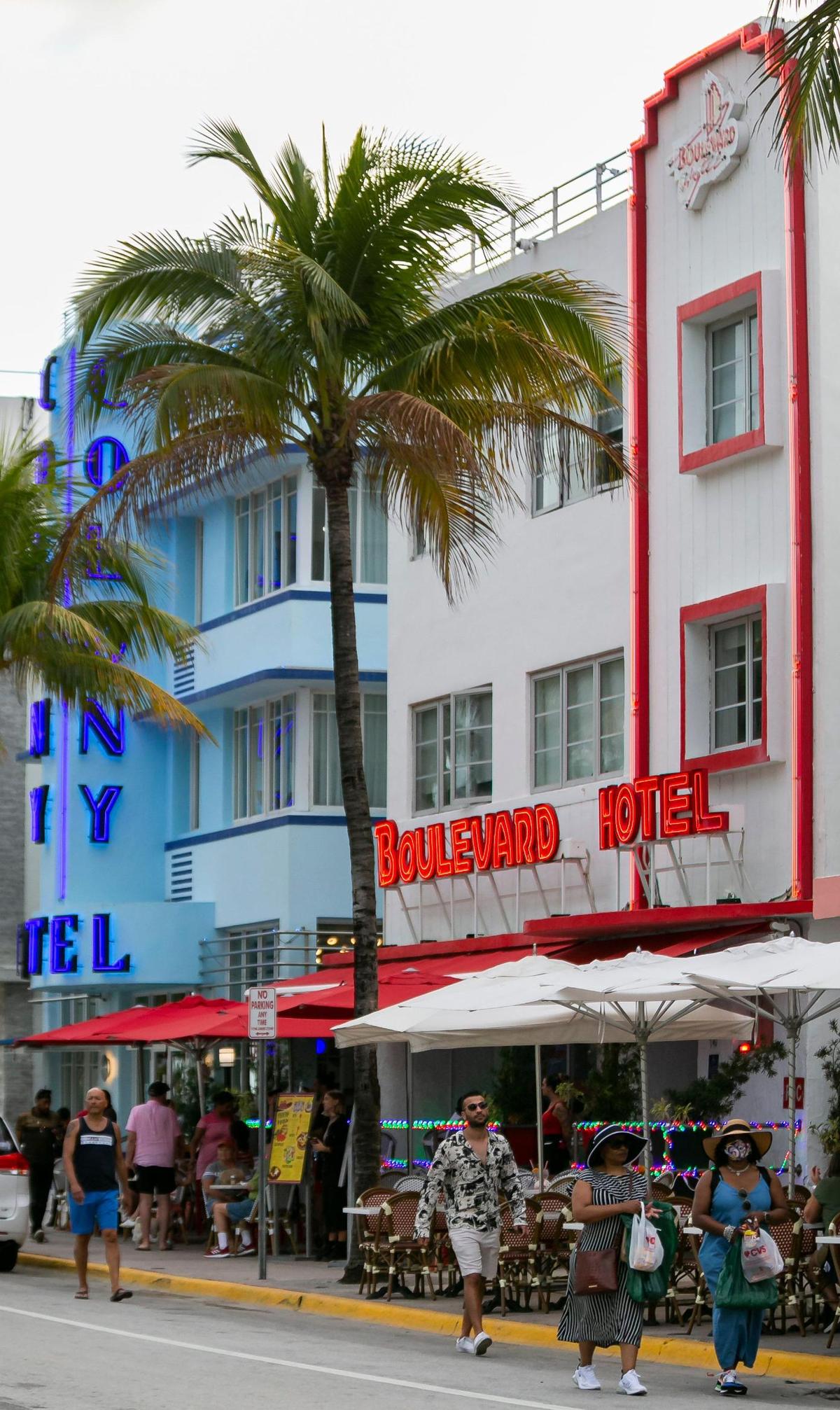 People walk down Ocean Drive near Boulevard Hotel in Miami Beach on Friday, Feb. 25, 2022.