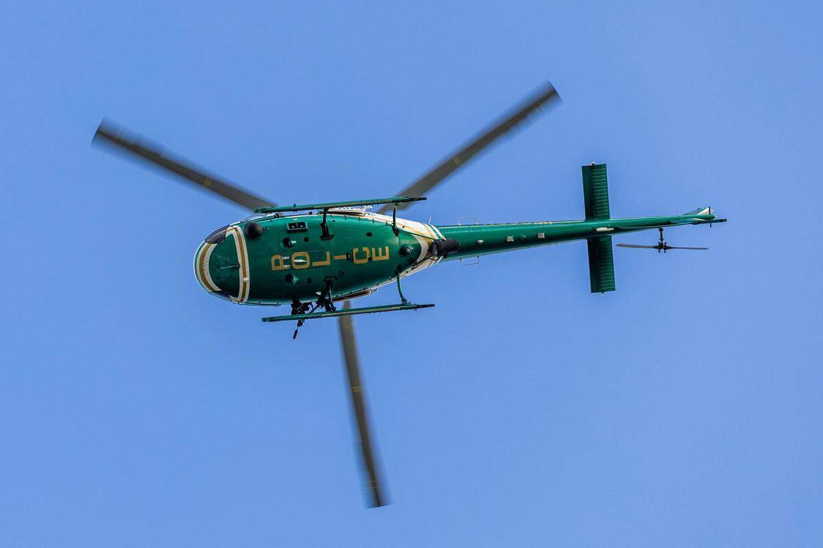 A Miami-Dade County Police helicopter soars over spectators during a South Florida Public Safety Regional Assets in Action Demonstration showcasing an active threat response incident in Biscayne Bay as part of the annual 2024 National Homeland Security Conference at PortMiami, Terminal J on Wednesday, July 24, 2024, in Miami, Fla.