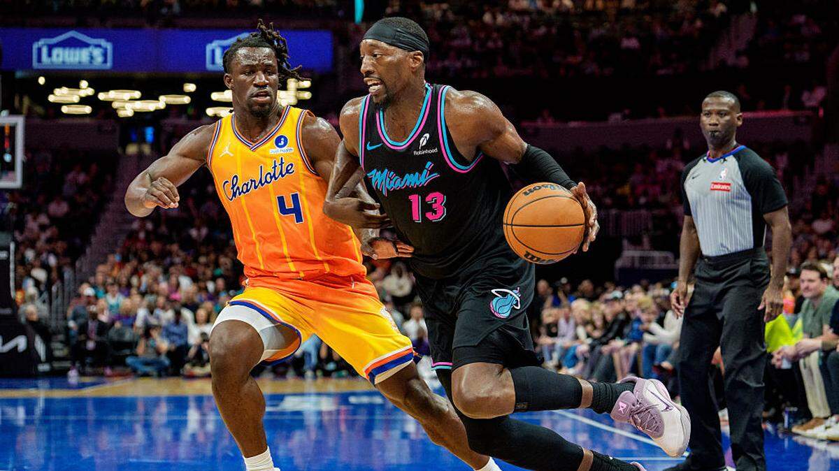 Bam Adebayo #13 of the Miami Heat goes to the basket while guarded by Sion James #4 of the Charlotte Hornets in the second half during their game at Spectrum Center on March 6, 2026 in Charlotte.