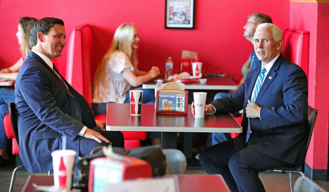 Vice President Mike Pence (right) has lunch with Florida Gov. Ron DeSantis in Orlando on Wednesday, May 20, 2020. Pence and the governor dined at Beth’s Burger Bar before heading to a round-table discussion on the Florida economy.