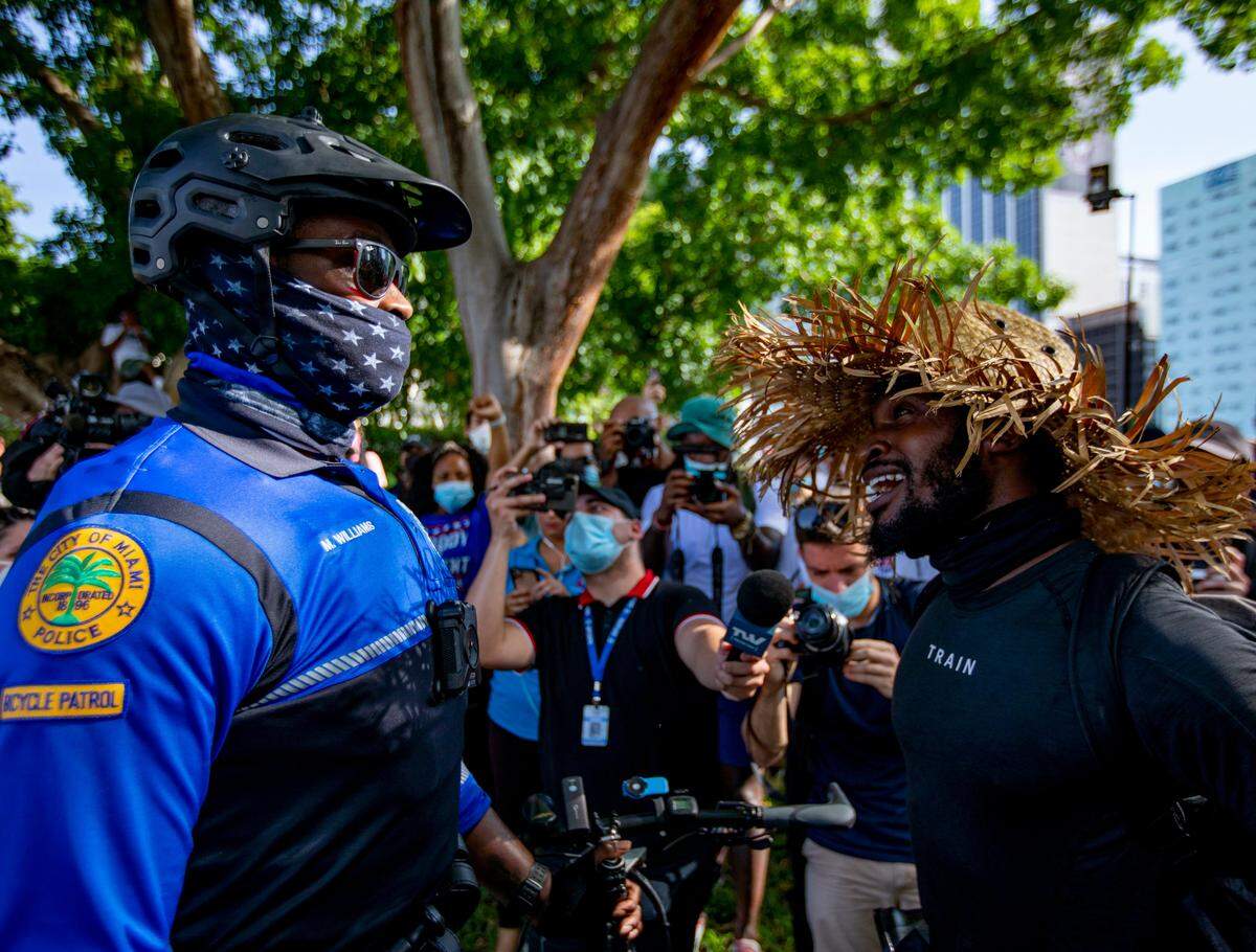 Little Haiti resident and protester Rene Charles, 25, has an exchange with a police officer during the second day of ‘Justice for George Floyd’ demonstrations on Sunday, May 31, 2020.