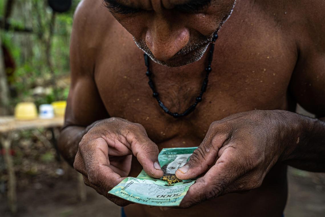 In Venezuela, a man blows onto gold he has just forged to cool it off. Although bringing Venezuelan-mined gold to the United States is illegal, it happens routinely, often routed through Miami, the very heart of opposition to the regime of Nicolás Maduro.