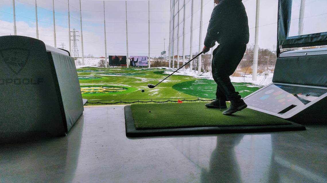 Topgolf is surrounded by netting to keep golf balls inside the driving range.