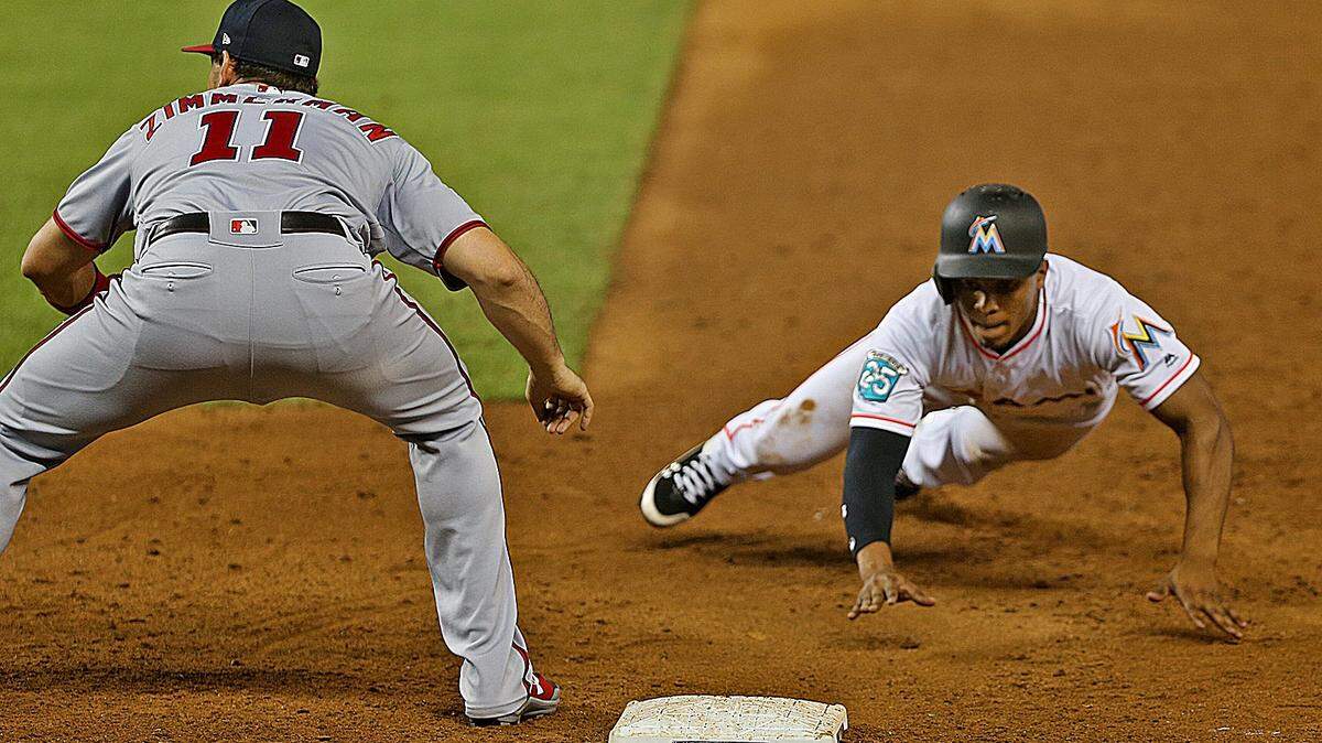 The Marlins #34 Magneuris Sierra slides safely back to first in the sixth inning as the Miami Marlins host the Washington Nationals on Monday, September 17, 2018.