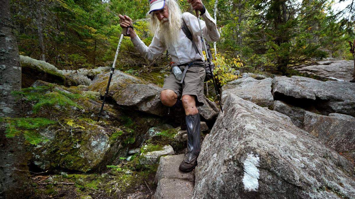 M.J. Eberhart, 83, carefully makes his way through large rocks while descending Mount Hayes on the Appalachian Trail, Sunday, Sept. 12, 2021, in Gorham, New Hampshire. Eberhart, who goes by the trail name of Nimblewill Nomad, is the oldest person to hike the entire 2,193-mile Appalachian Trail.
