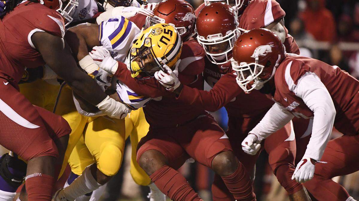 LSU running back Nick Brossette pushes through the Arkansas defense to score a touchdown during the first half of a 24-17 victory against host Arkansas on Saturday.