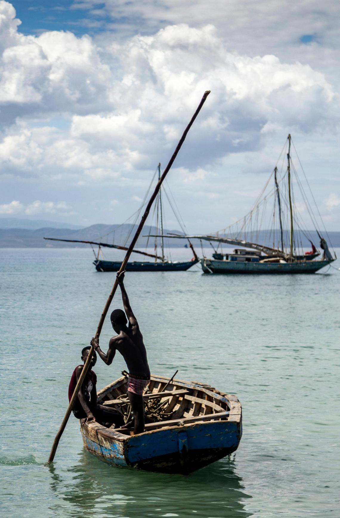 Two boys head out from the beach on March 26, 2022, after dropping off passengers at the village of La Vallée on Île de la Tortue in northwest Haiti.
