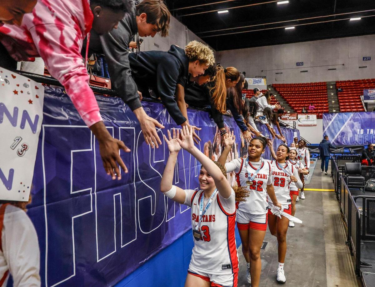 Miami Country Day players celebrate with spectators after defeating Providence School for the FHSAA Class 2A Girls High School Basketball State Championship at the RP Funding Center in Lakeland, Florida on Saturday, March 1, 2025.
