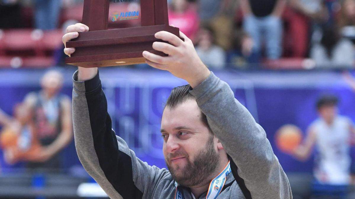 St. Thomas Aquinas head coach Oliver Berens raises the State Championship trophy after his team defeated Bloomingdale in the Class 6A final during the Florida High School State Championships at the RP Funding Center in Lakeland, Fl on Friday March 8, 2024. St. Thomas defeated Bloomingdale 70-35.