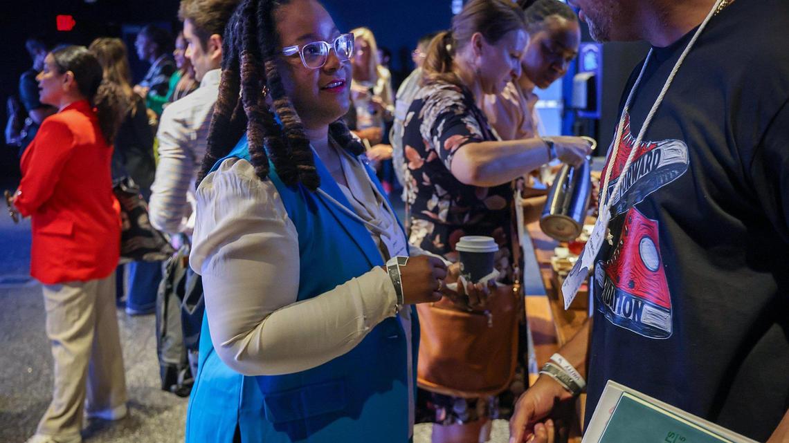 Ashley L. Eubanks Johnson, left, talks with fellow “hero” Christopher Cisco, right, as Radical Partners hosted the event “Neighborhood Heroes Connect,” a conference that brought together local grassroots leaders with funders at the Phillip & Patricia Frost Museum of Science, located inside the planetarium, on June 5, 2025, in Miami, Florida.