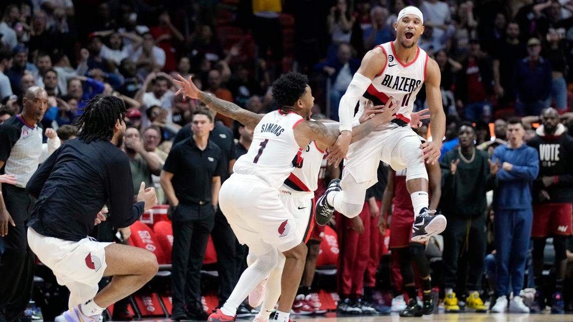Portland Trail Blazers players mob guard Josh Hart (11) after he made a 3-point shot at the buzzer to win an NBA basketball game against the Miami Heat, Monday, Nov. 7, 2022, in Miami.