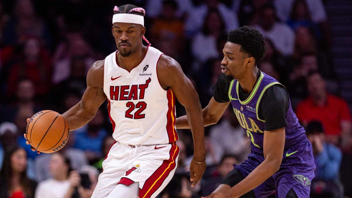 Miami Heat forward Jimmy Butler (22) dribbles while defended by New Orleans Pelicans forward Herbert Jones (2) during the first quarter of an NBA game at the Kaseya Center on Wednesday, January 1, 2025, in Miami, Fla.