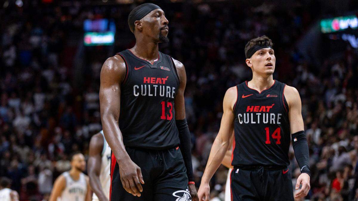 Miami Heat players Bam Adebayo (13) and Tyler Herro (14) react to a play during the second half of an NBA game against the Minnesota Timberwolves at Kaseya Center in Miami, Florida, on Monday, December 18, 2023.Monday, December 18, 2023.