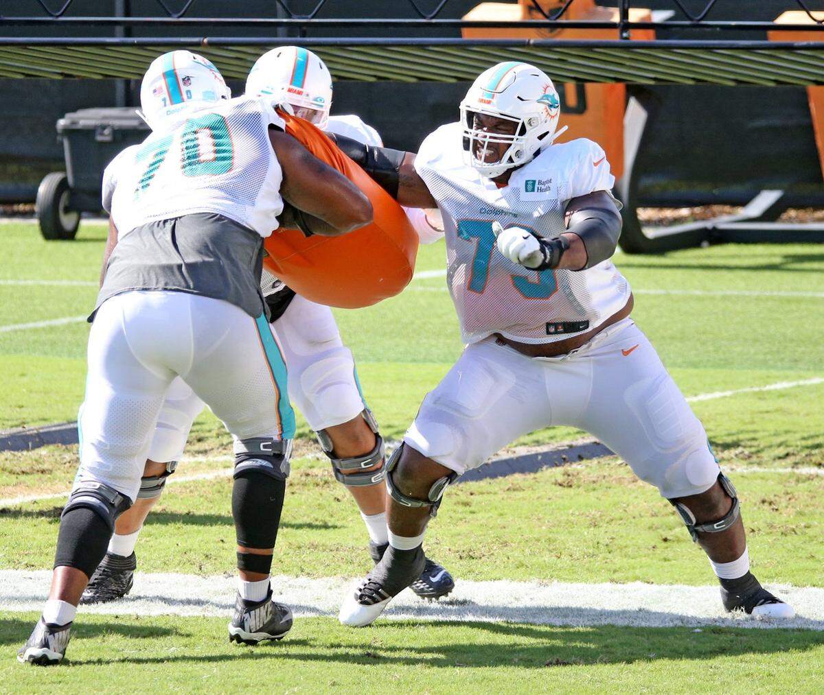 Miami Dolphins tackle Julien Davenport (70) prepares to take a hit from tackle Austin Jackson (73) during training camp at their training facility, Florida, August 31, 2020.