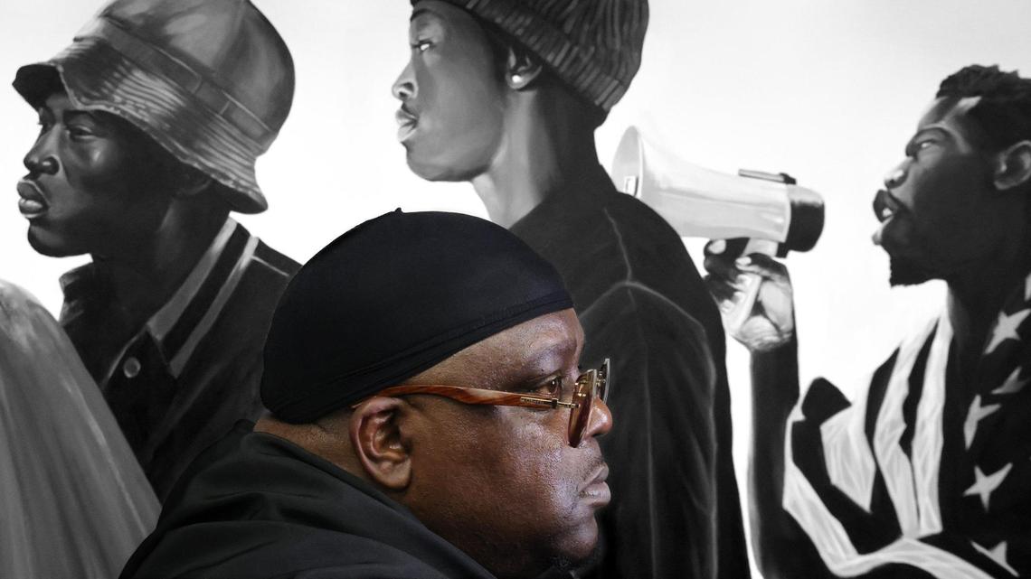 Muralist Addonis Parker, who opened his exhibit and Still We Rise in Opa-locka, is photographed among his artwork dealing with Black identity, liberation, and strength at his studio on Tuesday, June 17, 2025, in Miami, Florida.