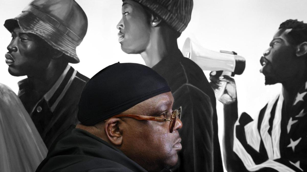 Muralist Addonis Parker, who opened his exhibit and Still We Rise in Opa-locka, is photographed among his artwork dealing with Black identity, liberation, and strength at his studio on Tuesday, June 17, 2025, in Miami, Florida.