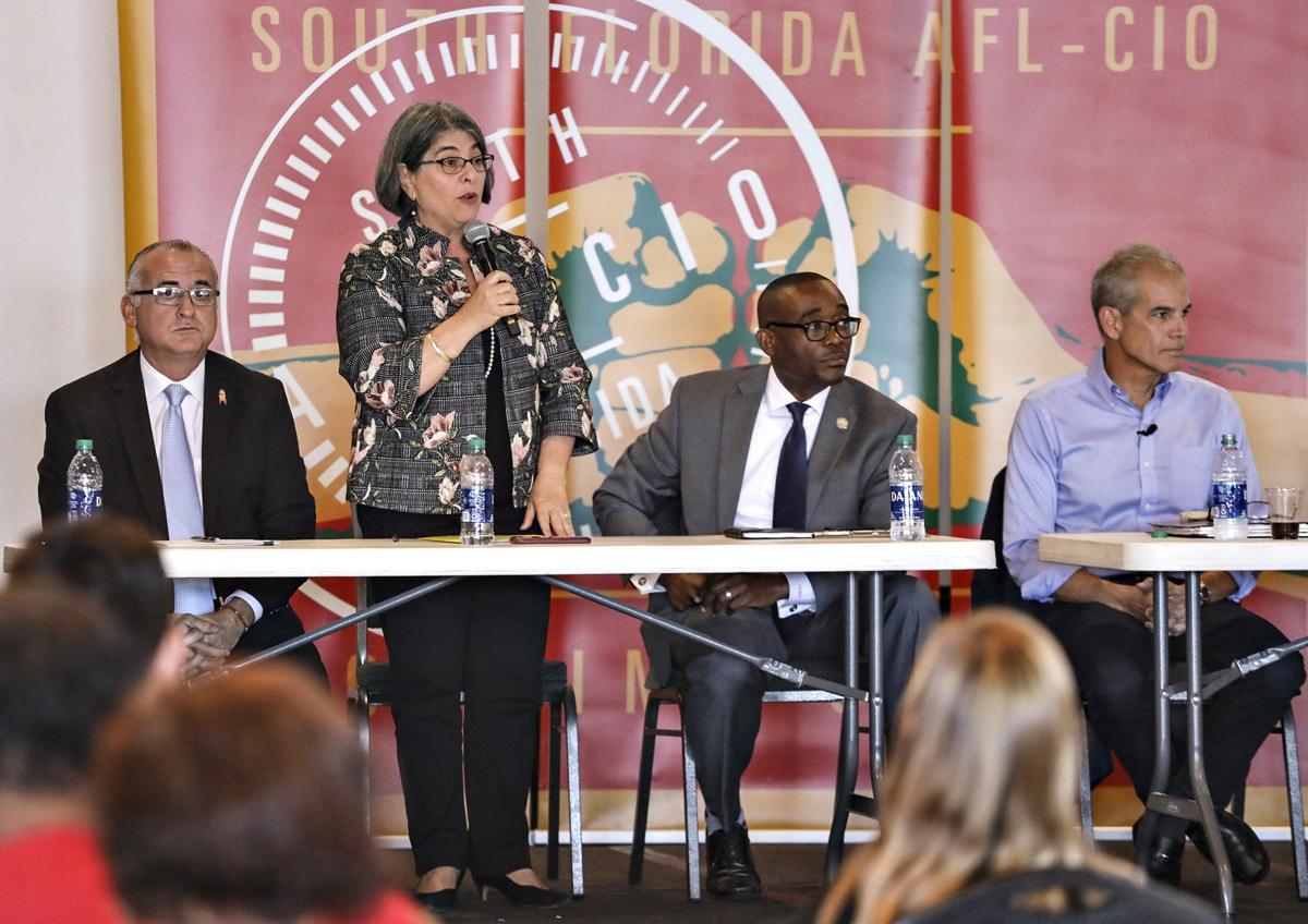Mayoral candidate Daniella Levine Cava answers a question as other candidates, from left, Esteban Bovo Jr., Jean Monestime and Alex Penelas listen during the Miami-Dade County Mayoral Candidate Forum at the Firefighters Memorial Hall in Doral, Florida, on October 21, 2019.