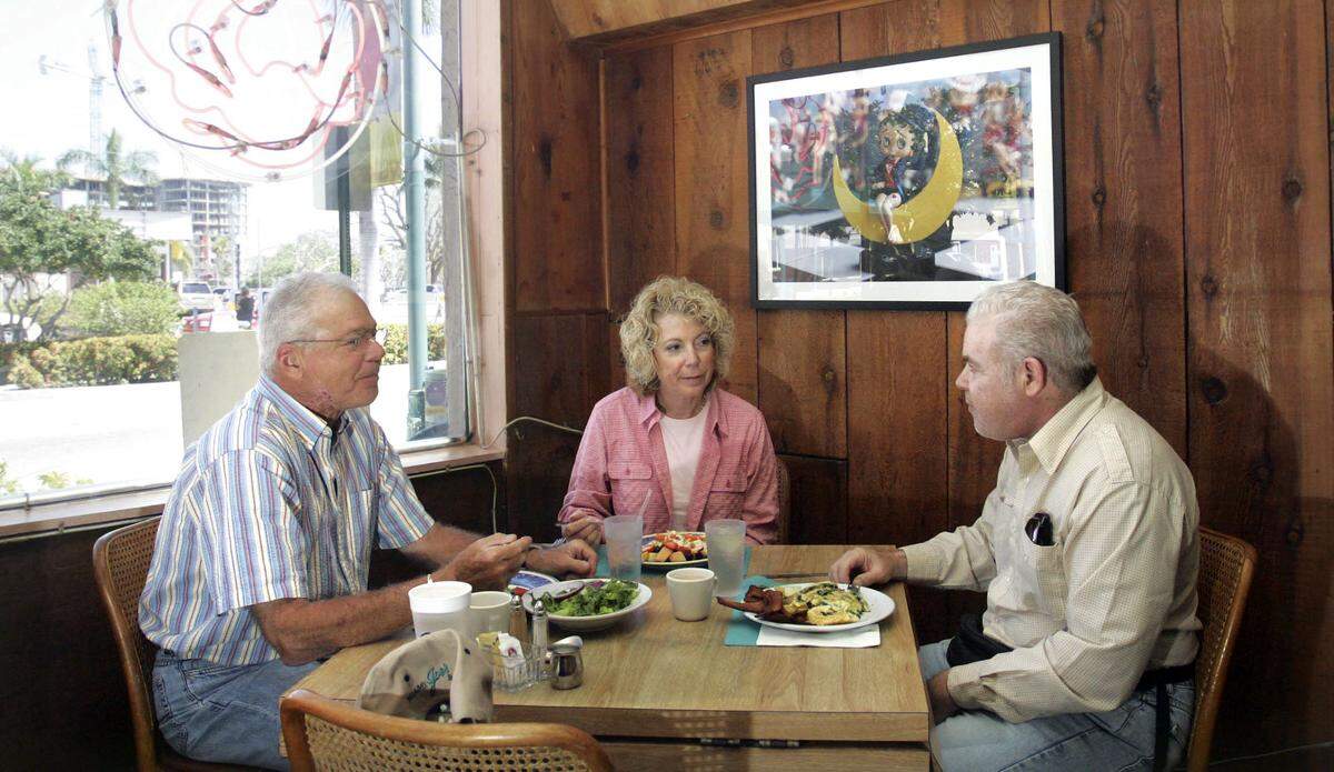 In 2006, Barry and Mary Bader of North Miami; and Kenny Bader, visiting from New City, enjoy a meal at the Coral Rose Cafe, 1840 Harrison St., in downtown Hollywood.