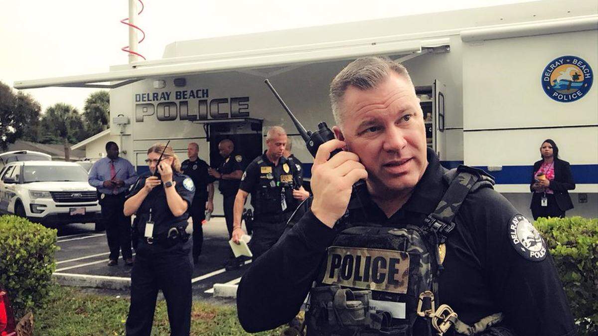 Delray Beach police Capt. John Crane-Baker, right, and Asst. Chief Rachel Saunders listen to radio traffic after SWAT operators entered a Villages at Delray apartment where two people were found dead Oct. 8, 2019. An infant was found unharmed.
