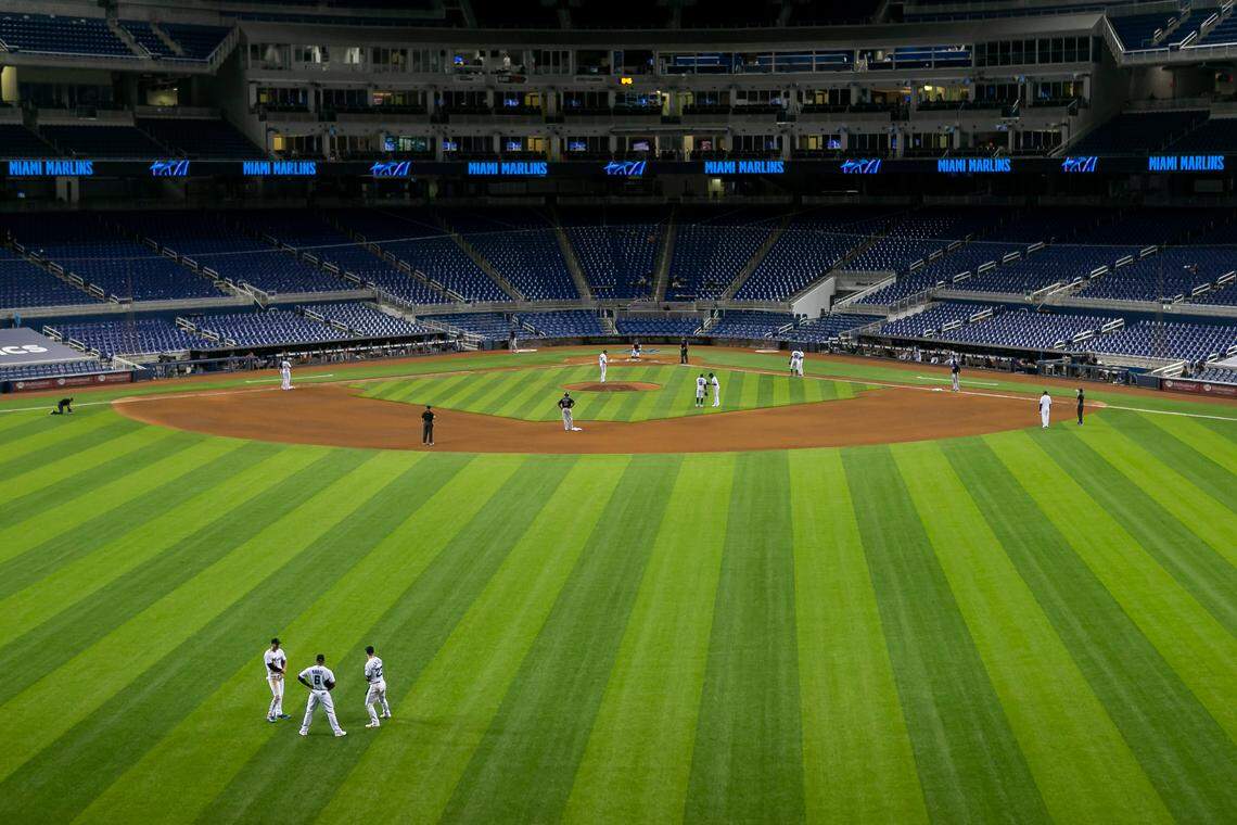 Miami Marlins right fielder Matt Joyce (7), center fielder Starling Marte (6) and left fielder Corey Dickerson (23) wait in the outfield during a pitcher change in the eighth inning of a Major League Baseball game against the Boston Red Sox at Marlins Park in Miami, Florida on Tuesday, September 15, 2020.