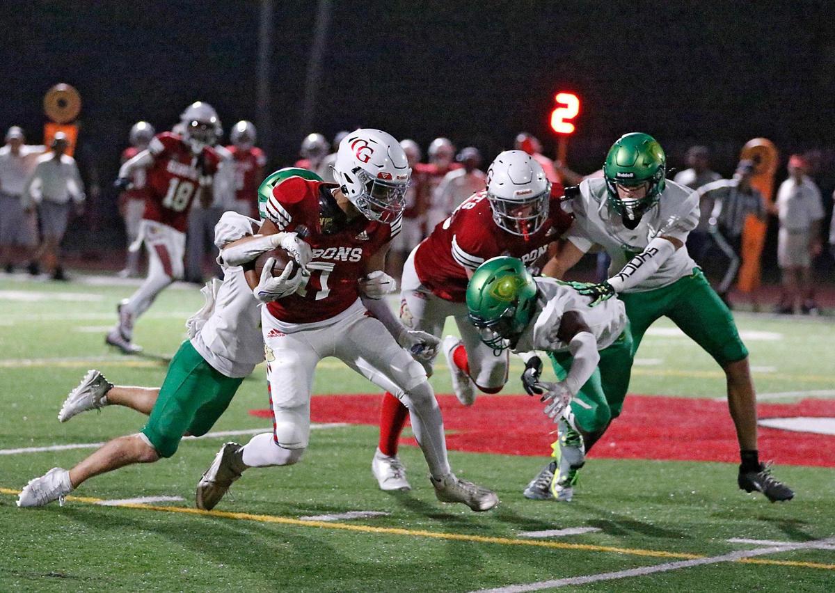 Cardinal Gibbons Chiefs wide receiver Logan Andrews (17) attempts to break free from Cardinal Gibbons Crusaders (NC) defenders during the Broward County National Football Showcase on Friday, August 25, 2023 at Cardinal Gibbons High in Fort Lauderdale. Andrew Uloza / for Miami Herald
