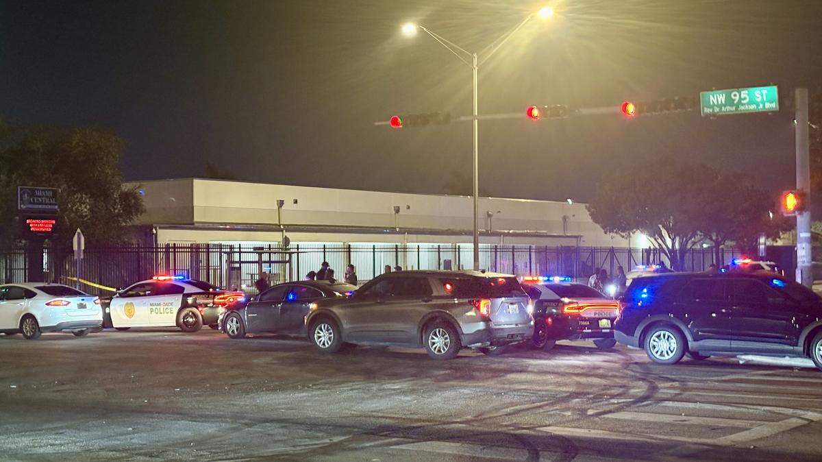 Police cars line up on the side of Miami Central Senior High, along Northwest 17th Avenue in Miami-Dade, Sunday evening, Dec. 28, 2025.