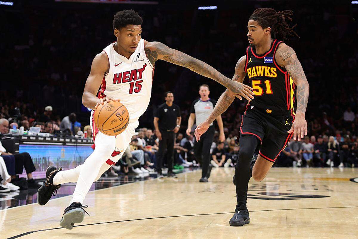 Myron Gardner #15 of the Miami Heat drives against Keshon Gilbert #51 of the Atlanta Hawks during the fourth quarter of the game at Kaseya Center on April 12, 2026 in Miami.