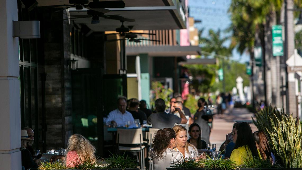 Doral, Florida, March 23, 2021 -People enjoy outdoor dining in bustling Main Street in Doral. Popular restaurants with locations elsewhere are eyeing Doral for their second locations. Doral has evolved in the last few years from a “logistics/warehouse” district to a place where residents can live, work and “play.” The city is trying to create a reputation as an art nexus; a central part of its downtown area has recently been rebranded as an arts district.
