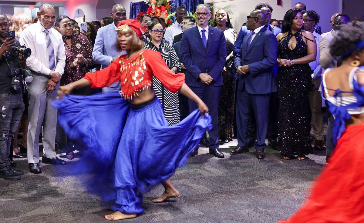 Haitian Prime Minister Alix Didier Fils-Aimé, center, watches as dancers perform during the official launch of  the new Haitian Consulate in Miami at Roz and Cal Kovens Center in North Miami, Florida on May 6, 2026.
