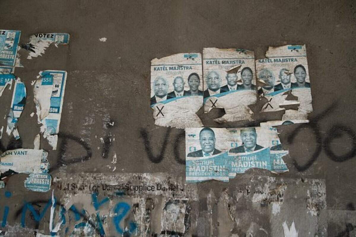 Political campaign posters from 2016 are visible on a wall in the city center in Port-au-Prince, Haiti, on July 31, 2026. Haiti's electoral council on July 27, 2026, set December 13 as the date for the crisis-wracked nation's first elections in a decade, pending the establishment of an "acceptable security environment." Elections have not been held in Haiti since 2016, and the country's last elected president, Jovenel Moise, was assassinated in 2021. (Photo by Clarens SIFFROY / AFP via Getty Images)