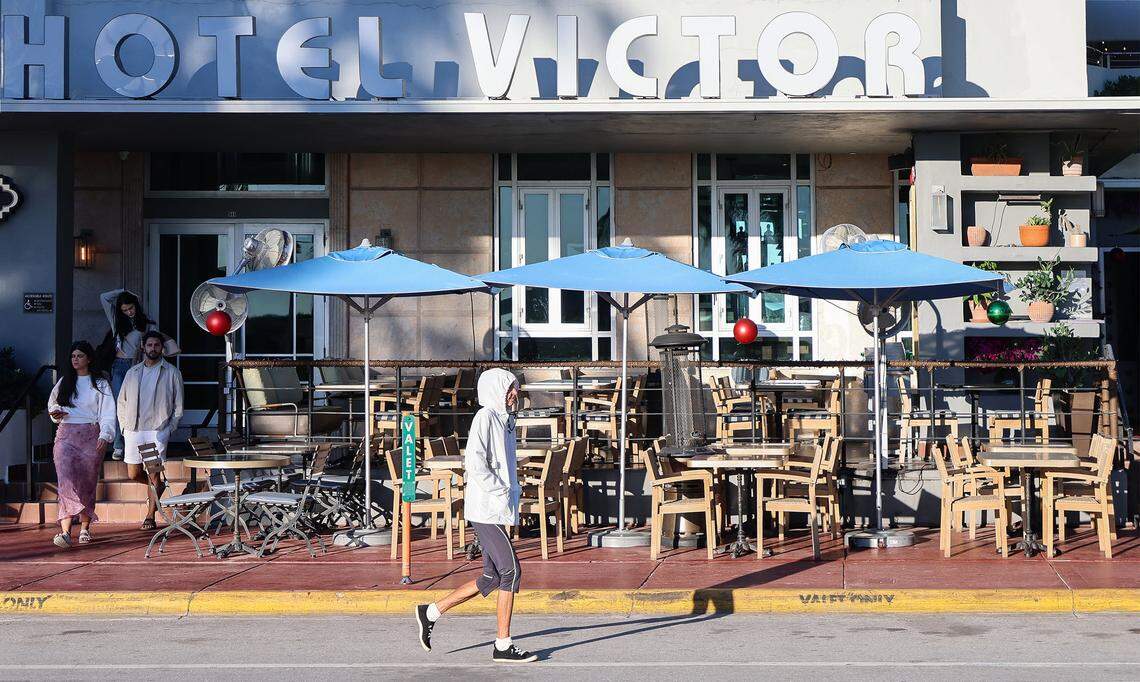 Morning strollers in South Beach dressed for the change in weather that saw temperatures fall into the 40s around South Florida on Dec. 31, 2025.