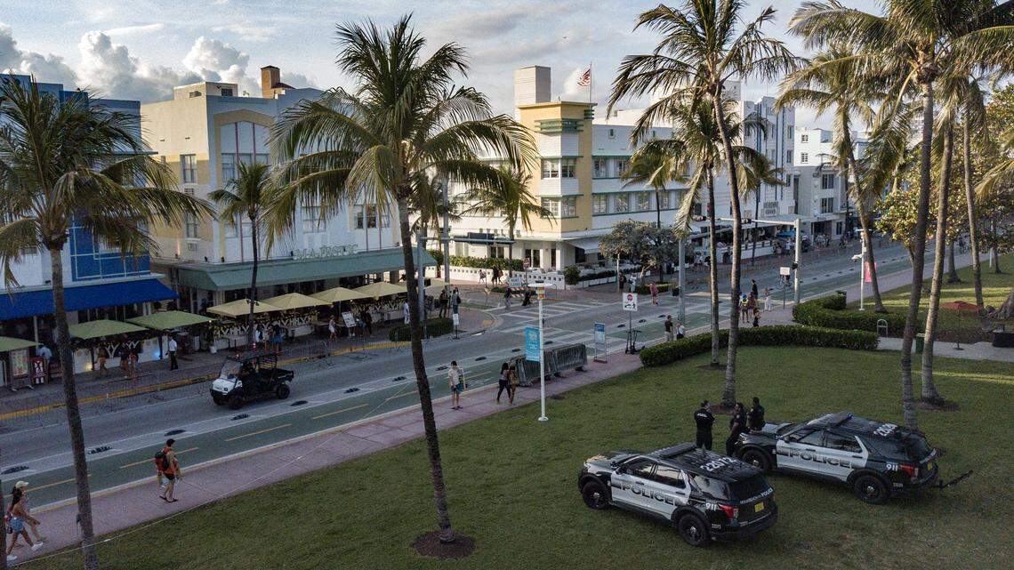 Miami Beach police officers stand watch along Ocean Drive during spring break on March 8, 2024. A man coerced a woman into prostitution and has been charged with human trafficking, Miami Beach police say. 
