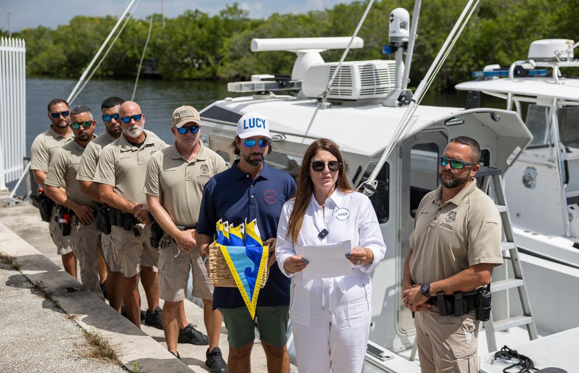 Melissa Fernandez and her husband, Andres Fernandez, present Fly High, Bird flags to members of the Miami-Dade Marine Patrol Unit at Black Point Park and Marina on Friday, Aug. 30, 2024, in Homestead, Fla. The Fernandezes, who started the Lucy Fernandez Foundation after their daughter was killed in a boat crash in 2022, hope to raise awareness about boat safety with the flags that will hang on various Miami-Dade Police vessels.