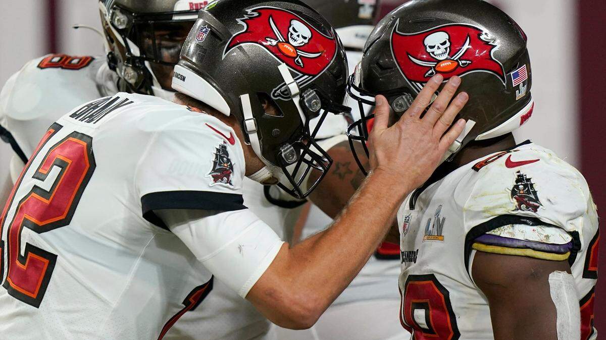 Tampa Bay Buccaneers running back Leonard Fournette, right, celebrates with teammate Tom Brady after scoring on a 27-yard touchdown run during the second half of the NFL Super Bowl 55 football game against the Kansas City Chiefs Sunday, Feb. 7, 2021, in Tampa.