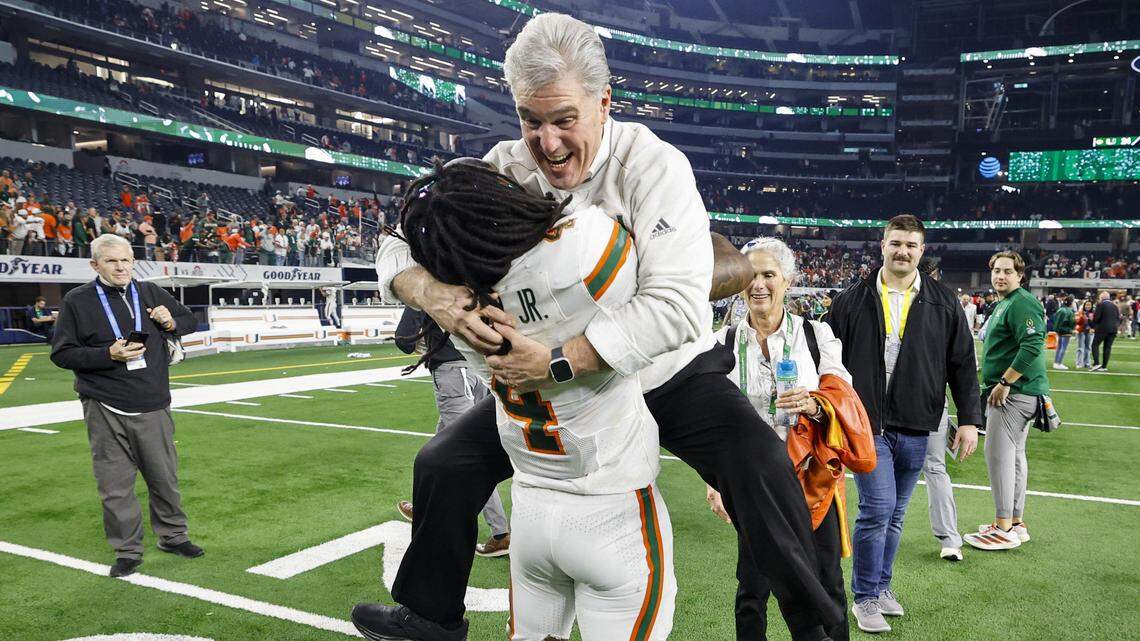 Miami Hurricanes Vice President / Director of Athletics Dan Radakovich leaps into the arms of Miami Hurricanes running back Mark Fletcher Jr. (4) after the Canes defeat against the Ohio State Buckeyes for the College Football Playoff quarterfinal game in the Cotton Bowl at AT&T Stadium in Arlington, Texas on Thursday, January 1, 2026.