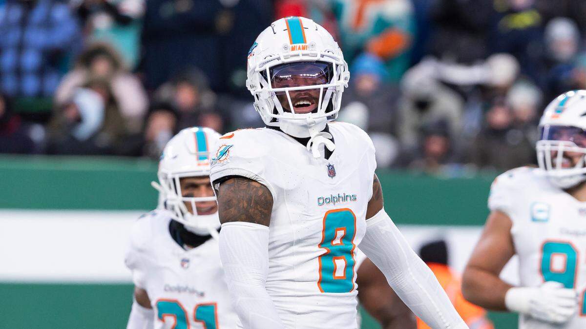 Miami Dolphins safety Jevon Holland (8) celebrates with linebacker Tyrel Dodson (11) after Dodson intercepted the ball from New York Jets quarterback Aaron Rodgers (8) in the first half of their NFL game at the MetLife Stadium on Sunday, Jan. 5, 2025, in East Rutherford, N.J.