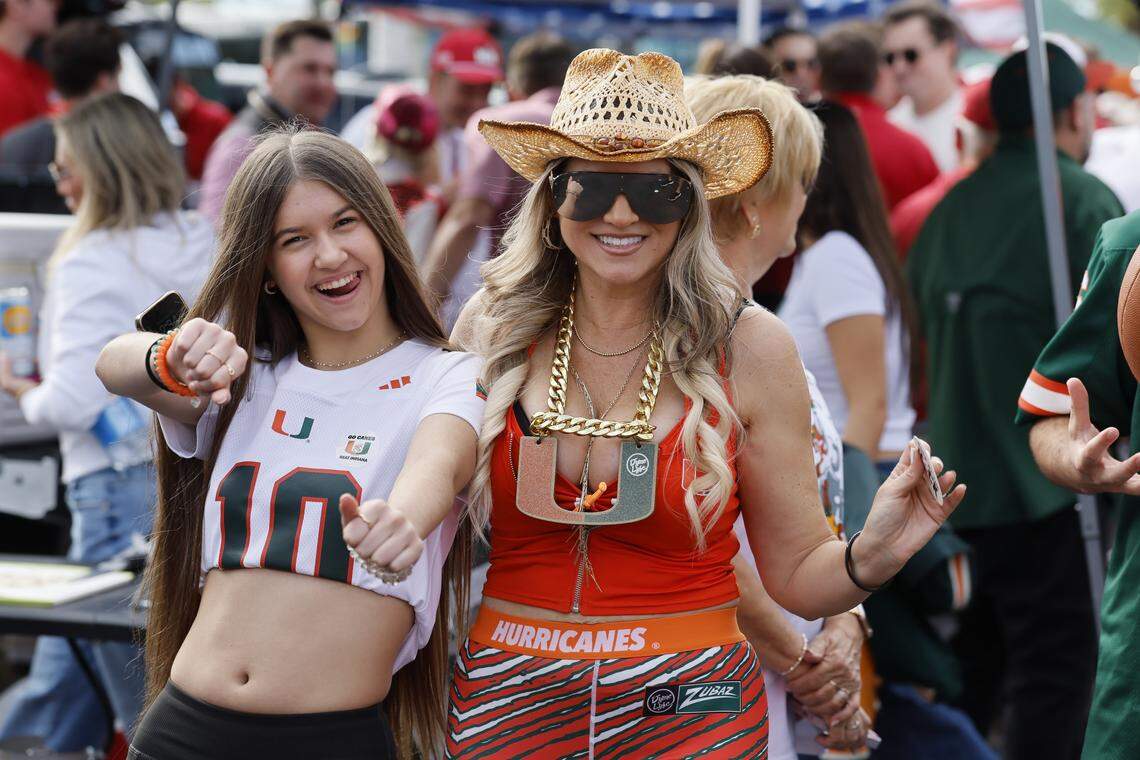 Miami Hurricanes fans Erica Ruble Lucena, at right, and daughter Skyla Lucena, 14, at left, dance at a tailgate party before the College Football Playoff National Championship Game between the Miami Hurricanes and the Indiana Hoosiers at Hard Rock Stadium in Miami Gardens, Florida, on Monday, January 19, 2026.