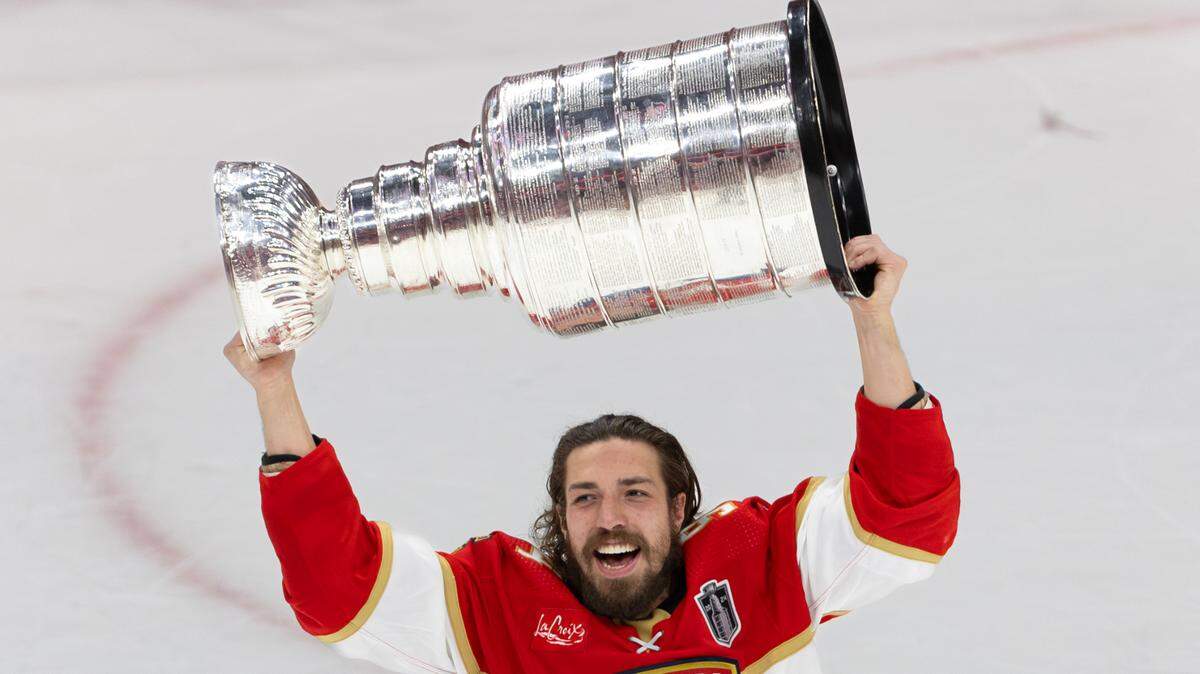 Florida Panthers left wing Ryan Lomberg (94) lifts the Stanley Cup after the Panthers defeated the Edmonton Oilers in Game 7 of the NHL Stanley Cup Final at the Amerant Bank Arena on Monday, June 24, 2024, in Sunrise, Fla.