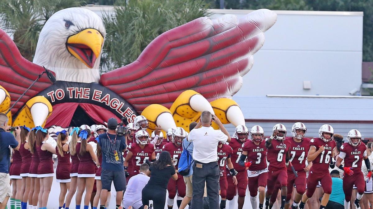 Marjory Stoneman Douglas football players take the field as they prepare to play South Broward Friday, Sept. 7, 2018, at Marjory Stoneman Douglas High School in Parkland.