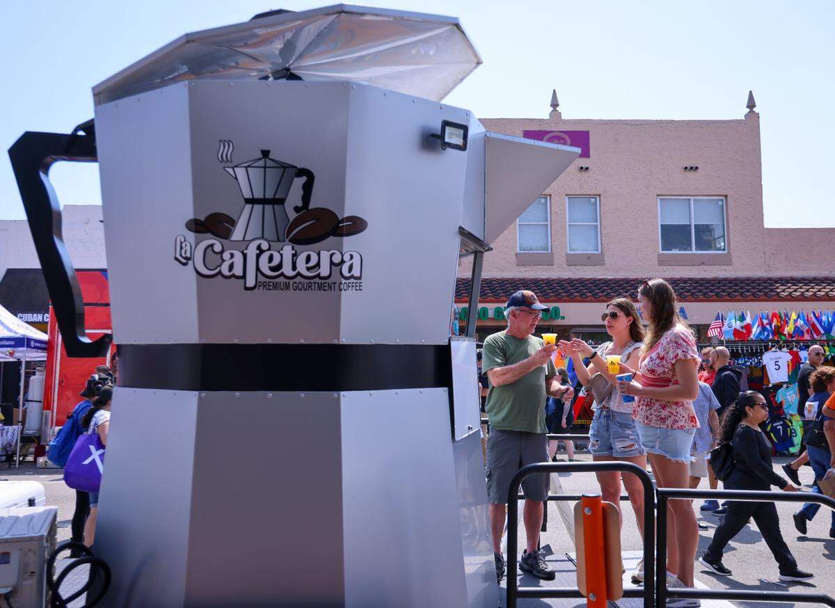 Festival goers stop for refreshment at the large scale coffee pot called the “Cafeteria.”