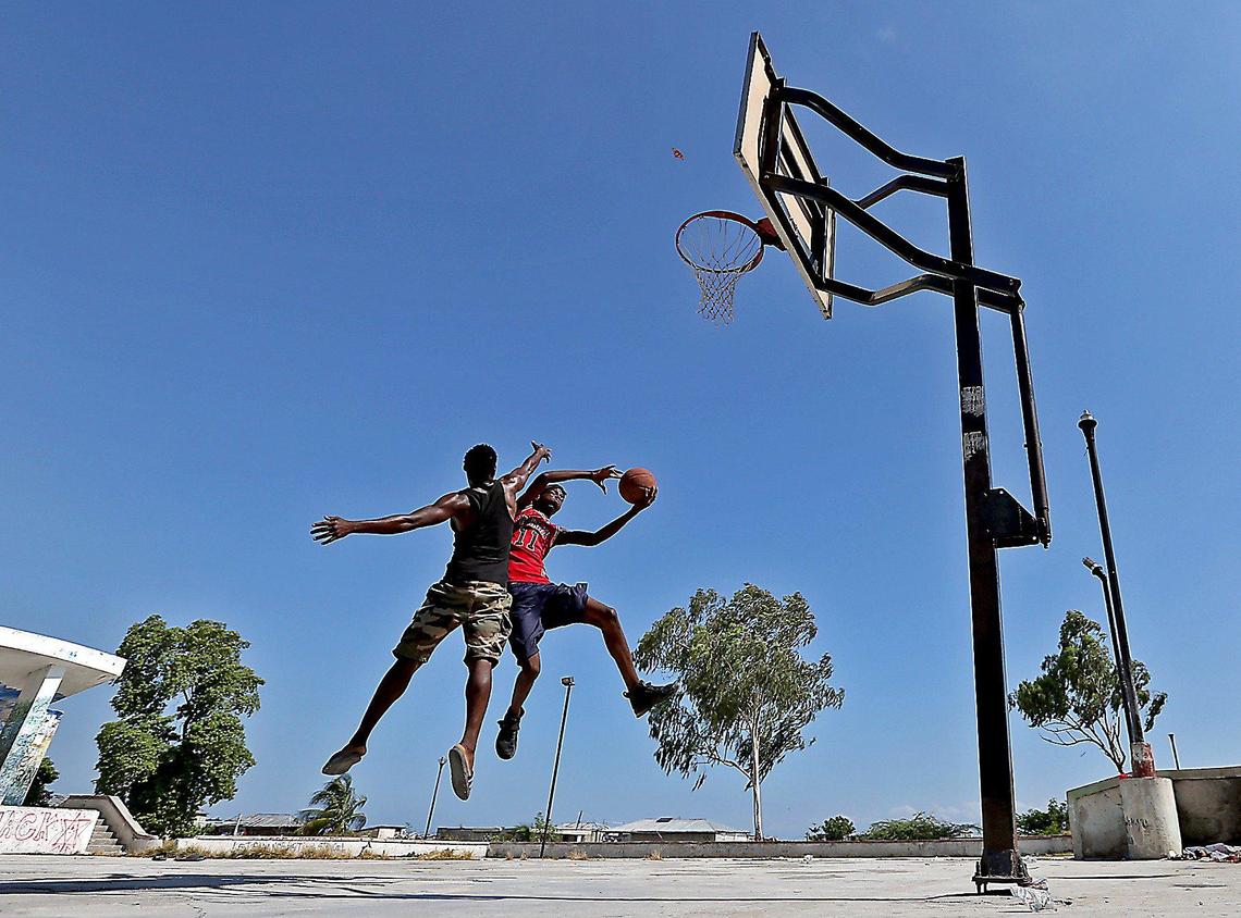 Young men in Haiti play a game of pickup basketball on the outskirts of Port-au-Prince.