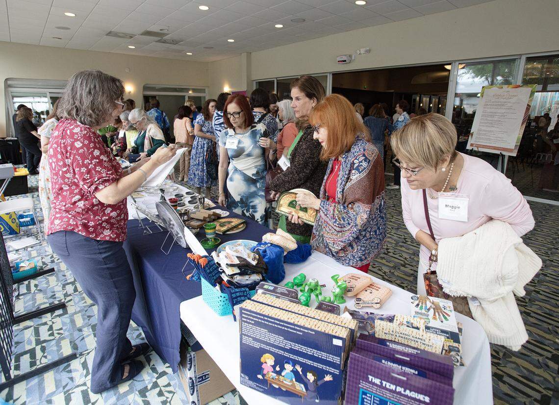 Women, the Third Annual South Dade Community Women's Passover Seder participants, explore Passover bazzar at Temple Judea on Sunday, March 30, 2026 in Coral Gables. Andrew Uloza / for Miami Herald