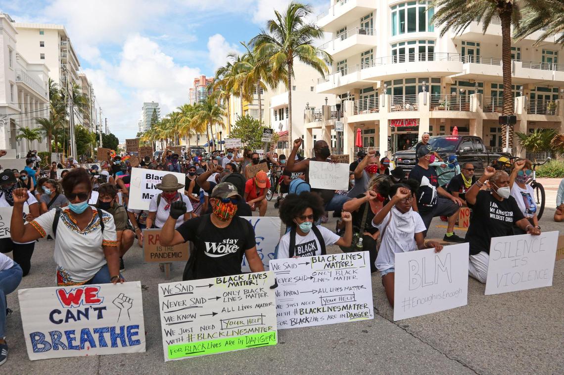 Protesters gather to take a knee for eight minutes, 46 seconds on Fifth Street and Ocean Drive during an anti-racism demonstration in Miami Beach on Sunday, June 14, 2020.