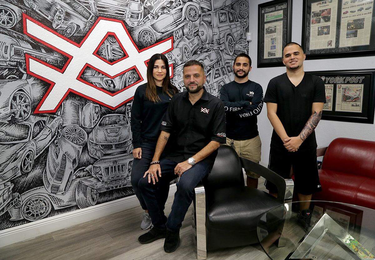 Alex Vega and his wife Aymara Vega, owners of The Auto Firm, also work with their sons Alex Jr. and Adriel Vega, far right, in their shop in Kendall, Thursday, Sept. 13, 2018.