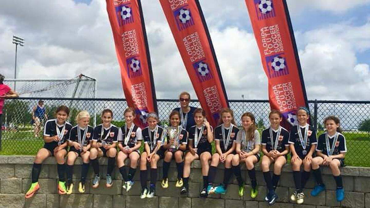 Miami Shores U11 girls with their coach Kate Wilson in Auburndale