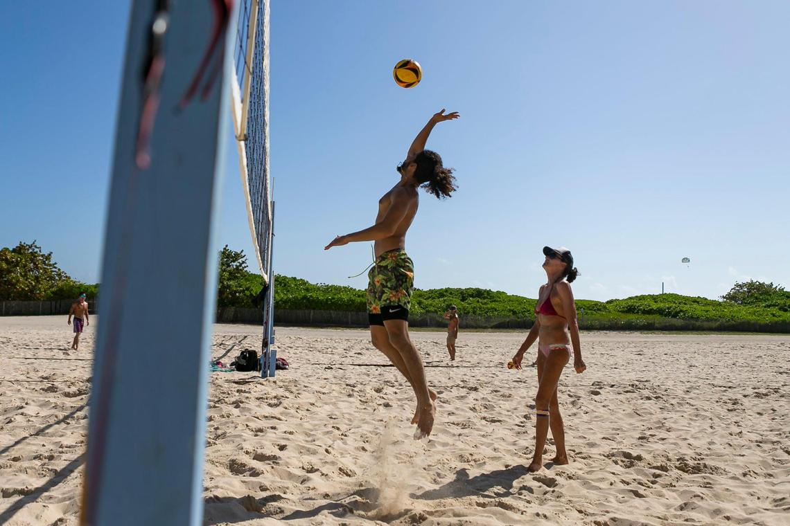 Gabriel Gonzalez, 22, and Bonnie Levin play volleyball at Lummus Park in Miami Beach, Florida on Monday, February 15, 2021.