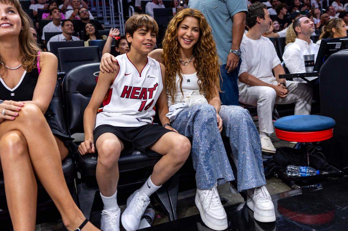 Singer Shakira, right, sits with her son Milan, left, during the second half of Game 3 of the NBA Playoffs between the Miami Heat and the Cleveland Cavaliers at Kaseya Center on Saturday, April 26, 2025, in Miami, Fla.