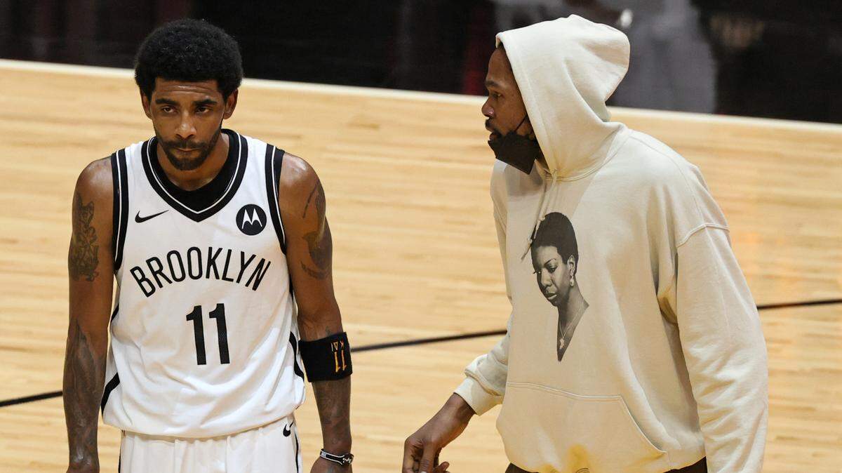 Brooklyn Nets guard Kyrie Irving (11) and teammate Kevin Durant talk in fourth quarter of NBA game against the host Miami Heat on April 18, 2021.