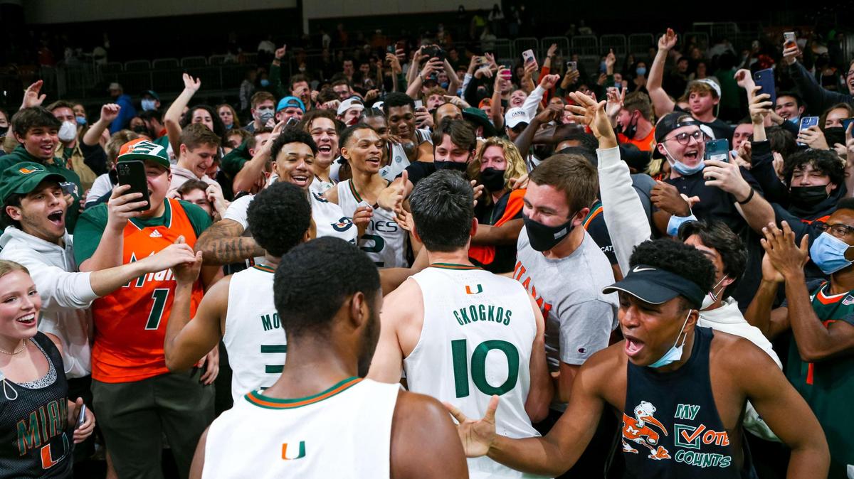 University of Miami players celebrate in the students section after defeating University of North Carolina 85-57 after the second half of an NCAA basketball game at the Watsco Center in Coral Gables, Florida, on Tuesday, January 18, 2022.